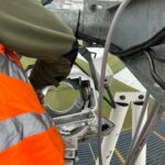 Rope access electrician working on a floodlight fitting at Headingley Cricket Ground