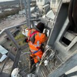 Rope access technician on a floodlight pylon platform at Headingley, Leeds