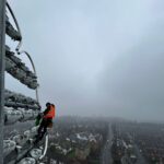 Rope access technician abseiling down a floodlight pylon at Headingley Cricket Ground