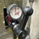 Anchor pull test with a calibrated tester during fall protection systems inspection
