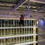Rope access technician working beneath the glass atrium roof at Leonardo Royal Hotel St Paul's