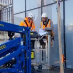 Rope access and MEWP team installing signage at height
